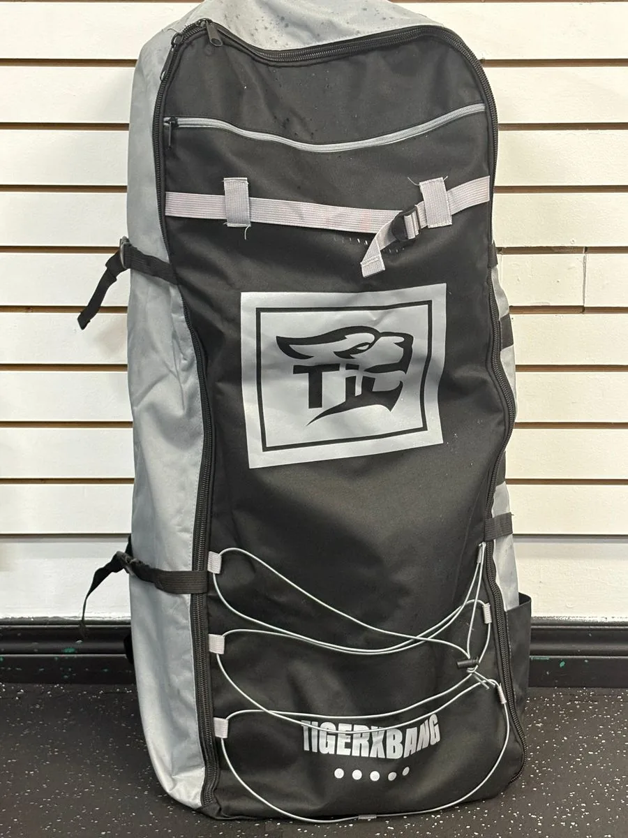 The inflatable paddle board packed into its carry bag, ready for pickup